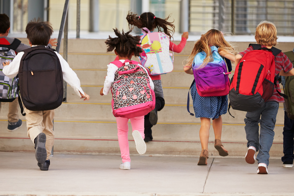Elementary,School,Kids,Running,Into,School,,Back,View BACK TO SCHOOL: NEW CDC STUDY SHOWS COVID SPREAD LOW