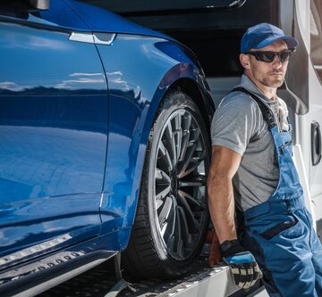 Car being towed on flatbed truck
