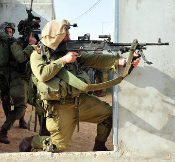 Israeli soldier firing gun