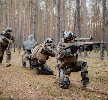 Camouflaged soldiers in the woods