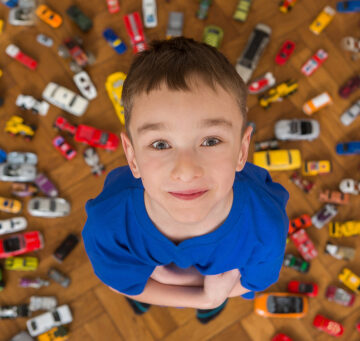 Boy with toy car collection