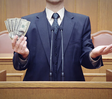 Political,Metaphors,,,Political,Rally,,,Politician,At,The,Debate, Politician with handful of dollars at microphone.