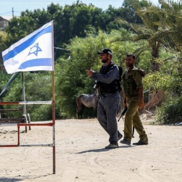 Israeli flag and soldier at checkpoint
