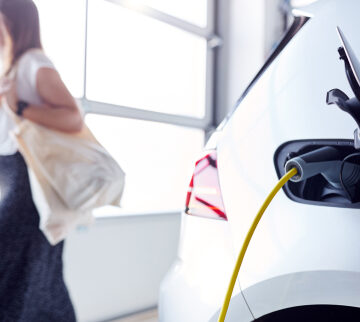 Woman and electric vehicle