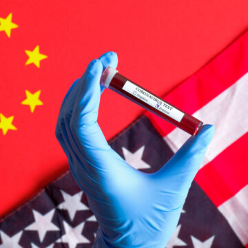 Novel,Coronavirus,Outbreak,In,Usa,Concept.,Nurse,Hand,Holding,Test Coronavirus outbreak concept. Hand holding test tube, U.S. & China flags