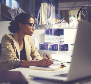 Experienced,Female,Administrative,Manager,In,Trendy,Eyewear,Organizing,Financial,Documents Female executive in office at the computer