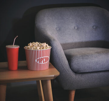 Table,With,Popcorn,And,Drink,Near,Comfortable,Armchair,Indoors.,Home Table with Popcorn and Drink Near Comfortable Armchair
