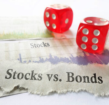 Stocks,Vs,Bonds,Newspaper,Headline,With,Dice,And,Stock,Charts Stocks vs Bonds on Newspaper with Headline, Dice and Stock Charts