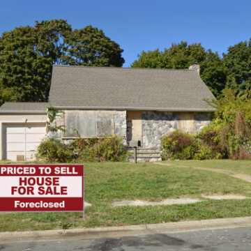 Boarded Suburban Cape Cod Brownstone Home in Residential Neighborhood