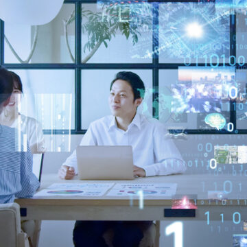 man and woman seated at table with computer language overlaid