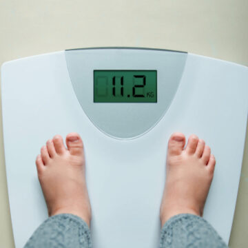 A Child's Feet on a Scale