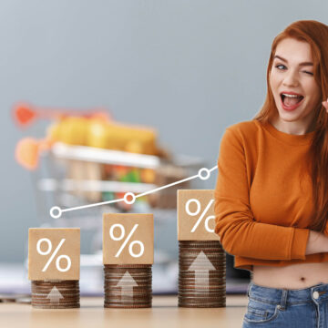 ECON-FED HIKES RATE A QUARTER POINT increasing stacks of coins representing percentage rates with a smiling young lady in the foreground indicating it's okay