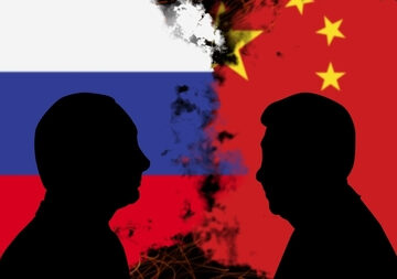 GEO-ANTI-CHINA RHETORIC FROM G7 MEETING Silhouettes of Russian President Vladimir Putin and Chinese President Xi Jinping Against Their Countries' Flags