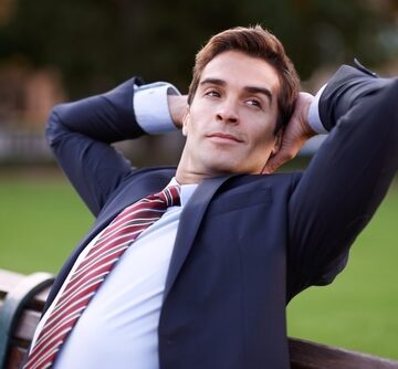 Taking,A,Breather.,A,Content,Businessman,Sitting,With,His,Hands A Content Businessman Sitting With His Hands Behind His Head Taking A Breather