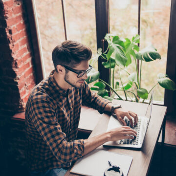 Top,View,Of,Handsome,Young,Man,In,Glasses,Typing,On IS AMAZON LOOKING TO CANCEL HUMAN AUTHORS?