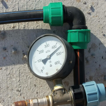 A pressure gauge on outside pipes