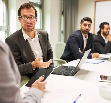 Business,Man,As,A,Consultant,In,A,Meeting,In,The Businessman/Consultant In A Meeting