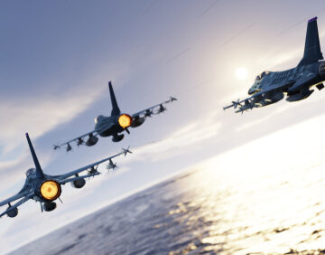 F-16,Jet,Fighters,Flying,Together,Above,The,Sea,Back,View F-16 Fighter Jets Flying In Formation Above The Sea At Low Altitude