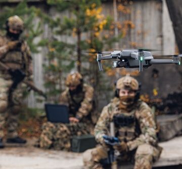 Military,Soldier,Controls,Drone,For,Reconnaissance,Operation,Of,Enemy,Positions. Military Soldier Controls Drone For Reconnaissance Operation Of Enemy Positions