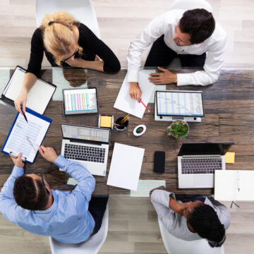 Overhead View Of A Team Of Corporate Executives Meeting At Conference Table