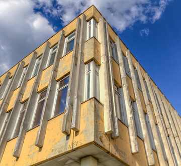 Run-down,Building,With,Blue,Sky,And,Clouds,Hdr BUILDINGS ARE BREAKING. THE CLIMATE CRISIS IS THE CAUSE.