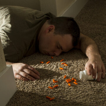 Man Passed Out Next To A Spilled Bottle Of Pills