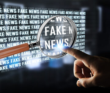 UKRAINE-MOSCOW ACCUSES NBC NEWS Finger Pointing Through Magnifying Glass At Screen With The Words Fake News Displayed