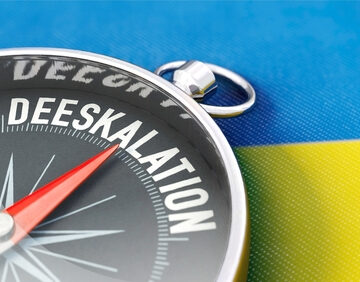 Concept Illustration Of Compass With The Word Deeskalation