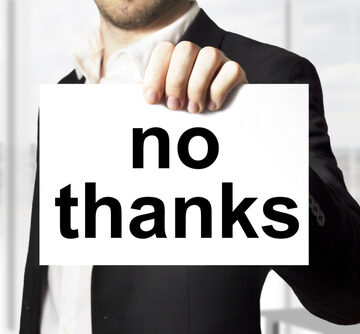 Businessman Holding Sign That Says No Thanks