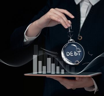 Debt Crisis Concept Declining Graph and Small Crystal Ball On A String Engraved With The Word Debt