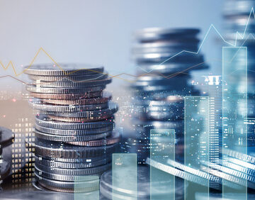 Double Exposure Of Graph And Rows Of Coins Representing Finance
