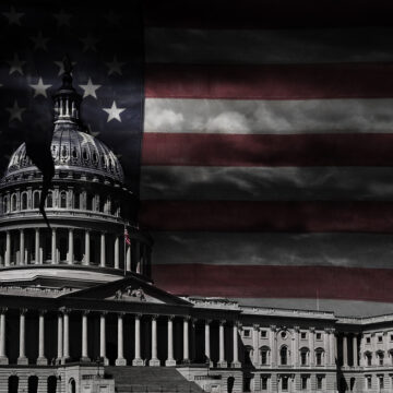 The United States Capitol Building With A Crack In The Dome And American Flag In The Background
