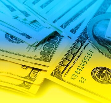 U.S. $100 Bills Overlaid With The Colors Of Ukraine