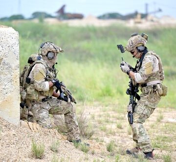 Fully-Armed American Soldiers Taking A Break