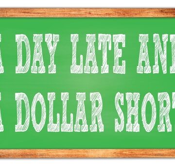 A Day Late And A Dollar Short Written On Green Chalkboard