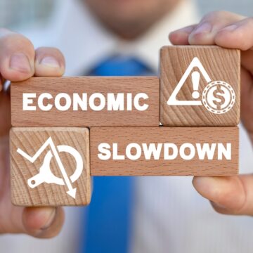 Concept Of Economic Slowdown Using Wooden Blocks With The Words Economic and Slowdown