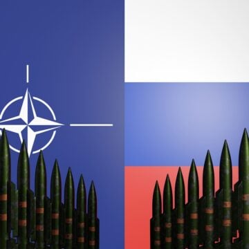 Nuclear Missiles Standing In Row With Nato And Russian Flags In Background