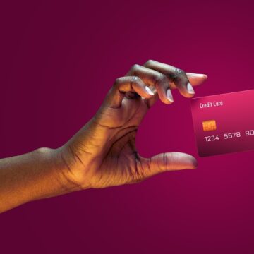 Close Up Of Woman's Hand Reaching For Levitating Credit Card