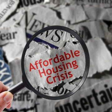 Affordable Housing Crisis Newspaper Headline Under Magnifying Glass