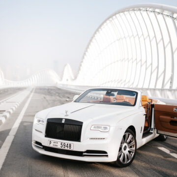 A Rolls-Royce On A Bridge At Dawn In Dubai