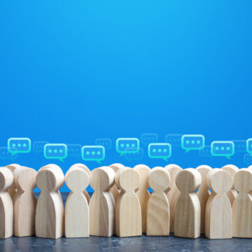 Wooden Figures With Comment Clouds Above Their Heads