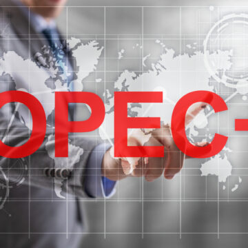 Concept Of Businessman Pointing To Rising Graph With OPEC+ On The Screen