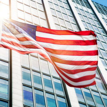 Floating American Flag In Front Of An Office Building
