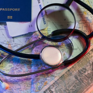 Concept Of Doctors Without Borders With Stethoscope, Tickets,, orld Map,Passport, and Currency
