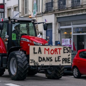 French Farmer On Red Tractor Protesting In Nancy, France