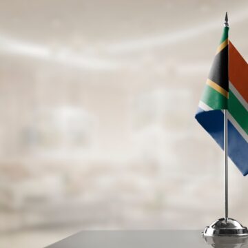 A Small South African Flag On An Abstract Blurry Background