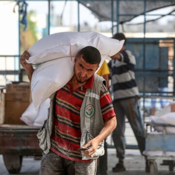 Palestinians Receive Food At An Aid Distribution Center