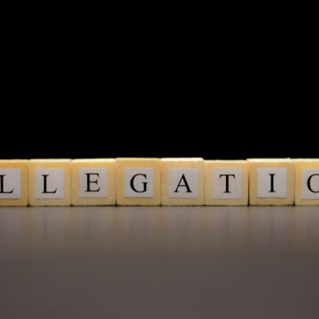 The Word Allegation Written On Wooden Cubes