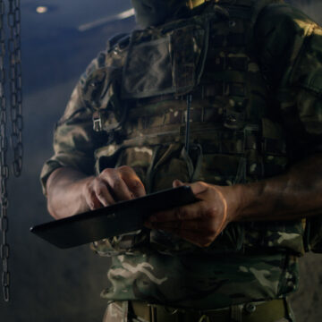 Dark Image Of Soldier Using Ipad