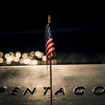 Close-up Of An American Flag In Front Of A Sign For The Pentagon